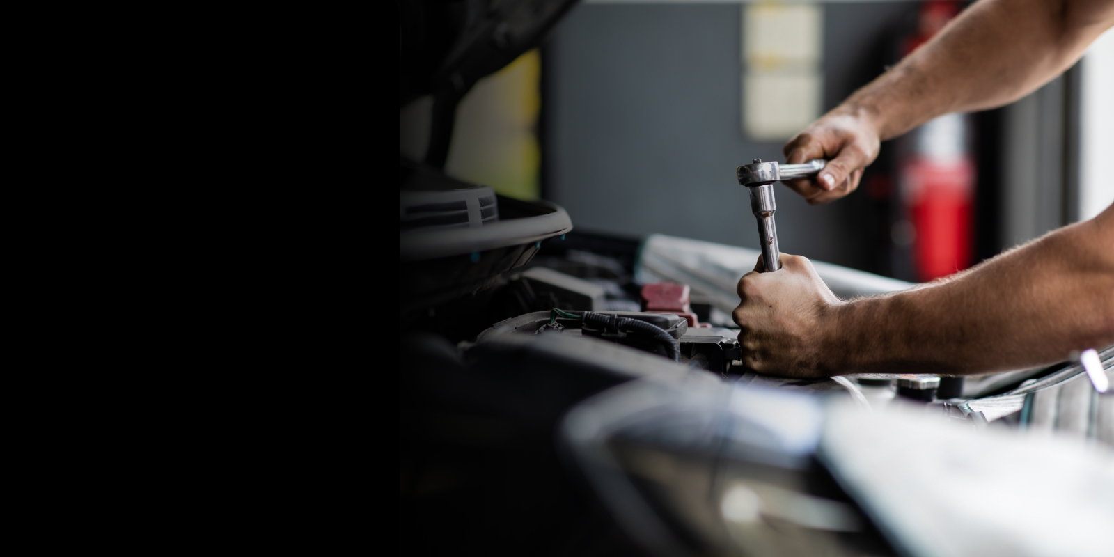 Hand of car mechanic with wrench. Auto repair garage.